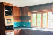 May be an image of cooker hood, kitchen island and indoors